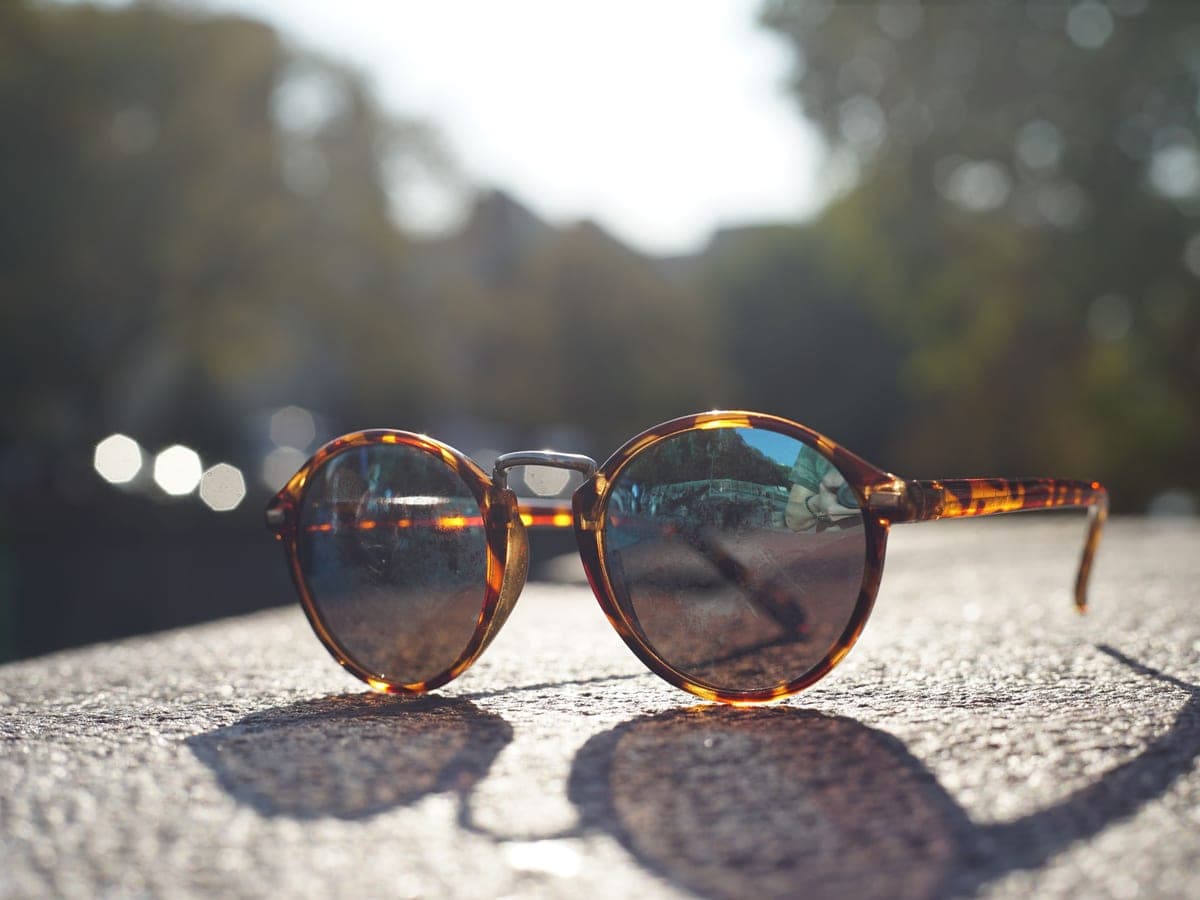 Tortoiseshell sunglasses on a sunlit surface — Shade & Signal, smart glasses & camera eyewear